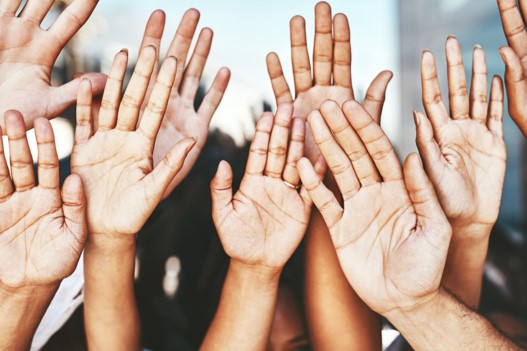 Many hands raised in the air
