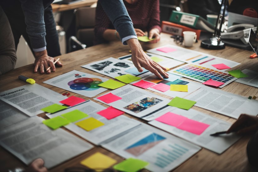 Various project plans spread across an executive's desk