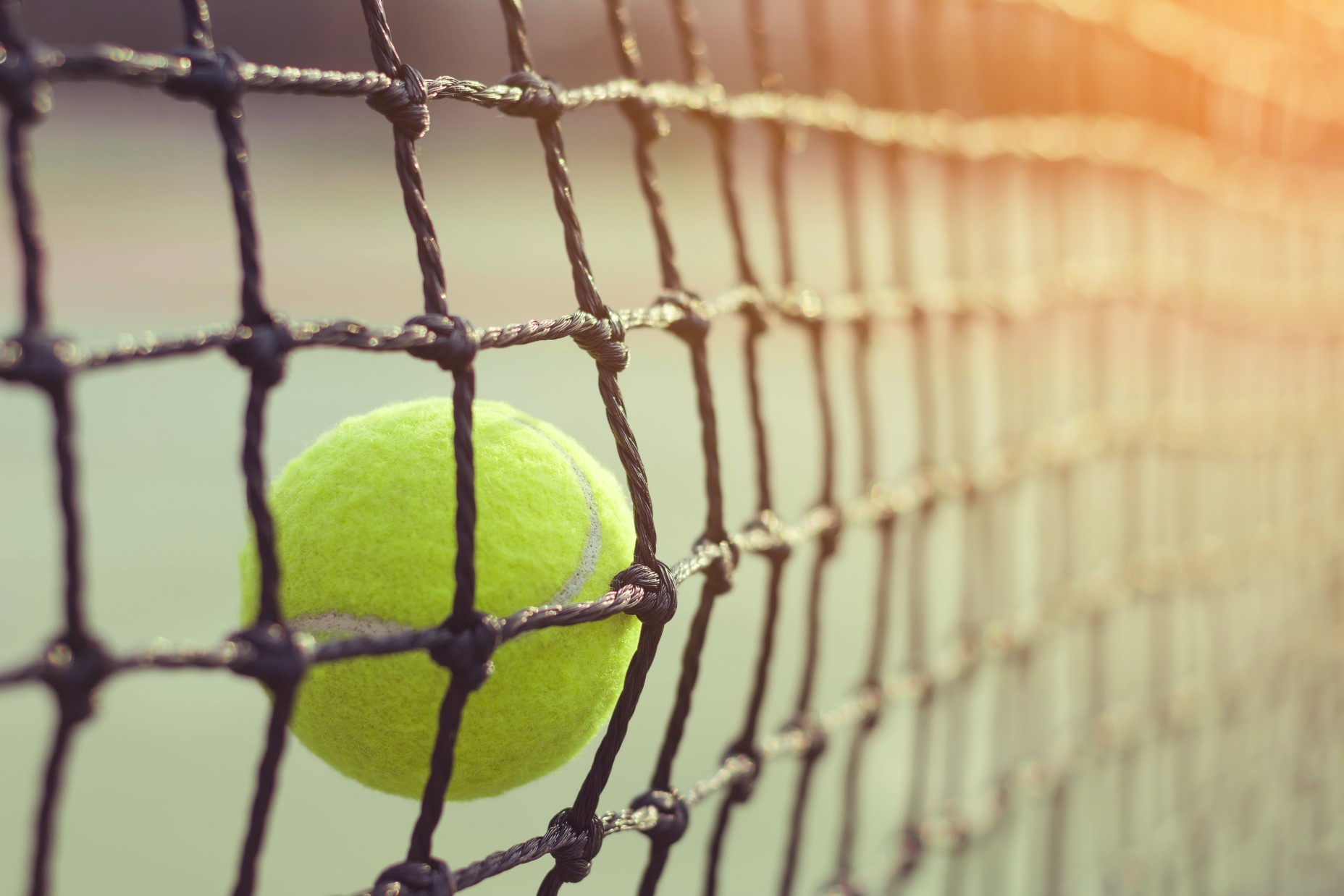 Tennis ball hitting the net