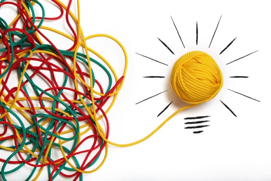 Colorful string in tangles coming together into a unified ball of yellow string