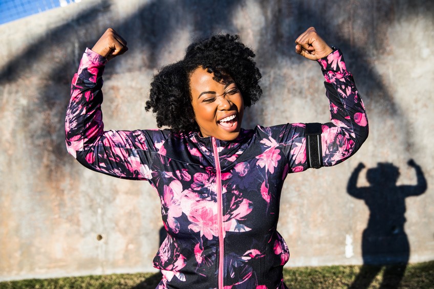 Athletic woman flexing her muscles in celebration